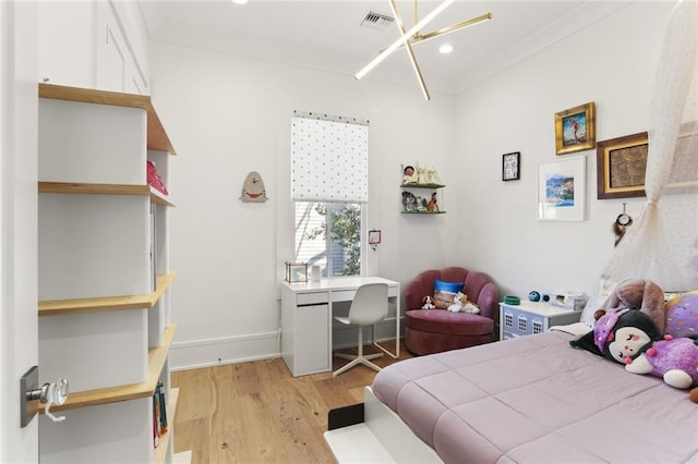 bedroom featuring visible vents, crown molding, baseboards, light wood-type flooring, and a notable chandelier