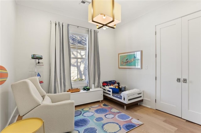 bedroom with visible vents and light wood-style floors