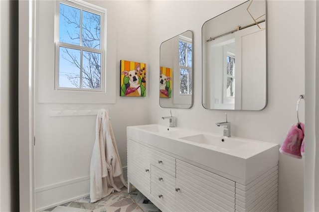 bathroom featuring plenty of natural light, a sink, and double vanity