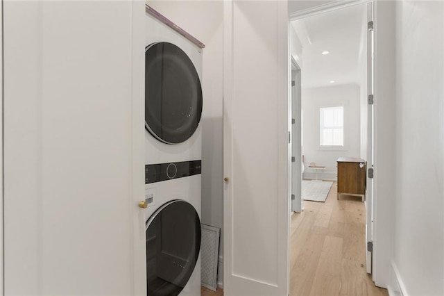 washroom featuring recessed lighting, light wood-style floors, laundry area, and stacked washing maching and dryer