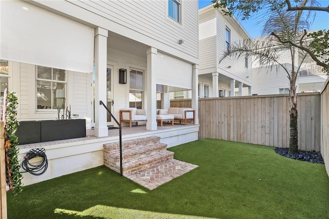 view of yard featuring a porch and fence