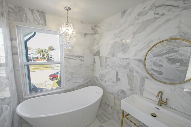 full bath with a soaking tub, tile walls, a chandelier, and vanity