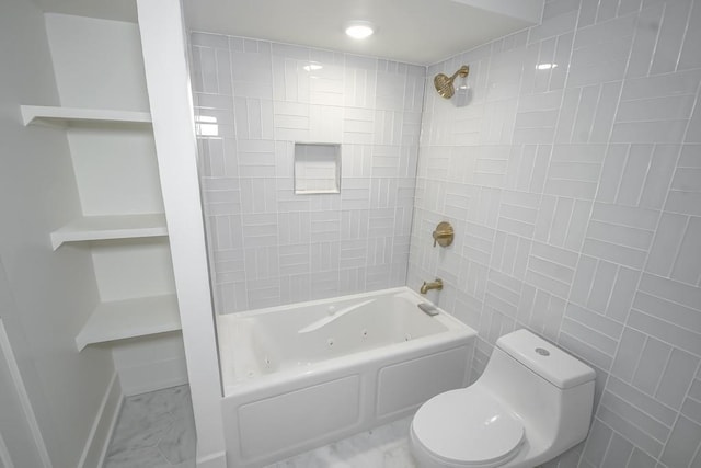 full bathroom featuring tile walls, marble finish floor, toilet, and a combined bath / shower with jetted tub