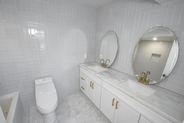 bathroom with double vanity, marble finish floor, toilet, and a sink