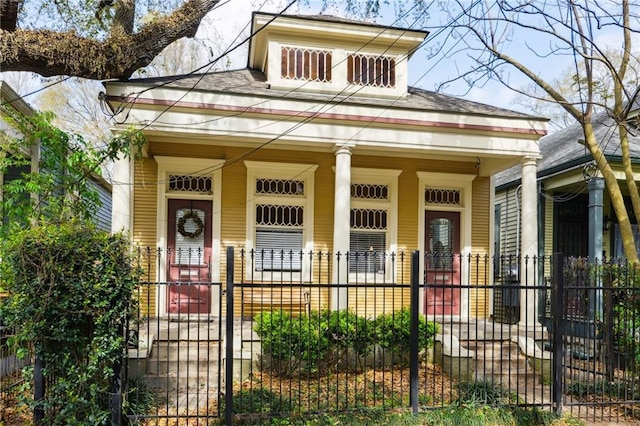 view of front of home featuring a fenced front yard and covered porch