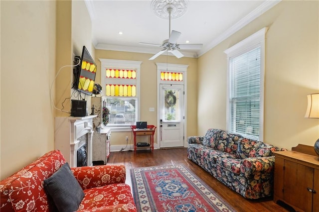 living area featuring ornamental molding, recessed lighting, a fireplace, wood finished floors, and a ceiling fan