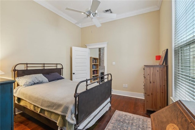 bedroom featuring visible vents, baseboards, ornamental molding, wood finished floors, and a ceiling fan