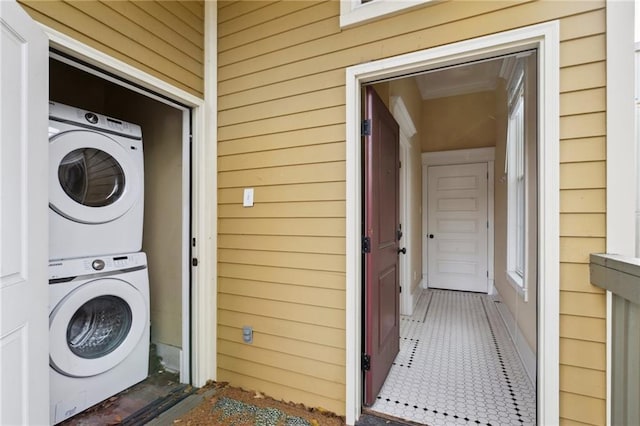 entrance to property featuring stacked washer and clothes dryer