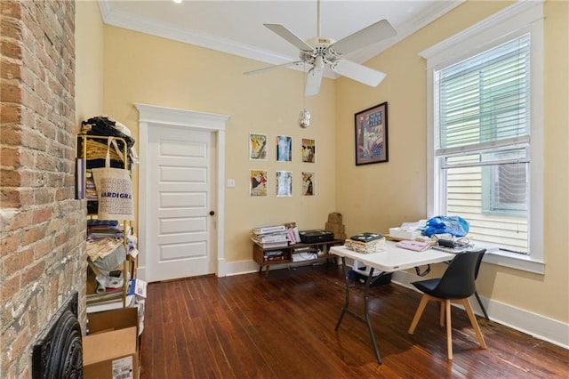 office area featuring a ceiling fan, hardwood / wood-style floors, a fireplace, crown molding, and baseboards