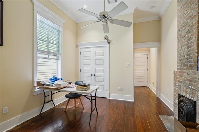 office space with visible vents, baseboards, a fireplace with flush hearth, ornamental molding, and dark wood-type flooring