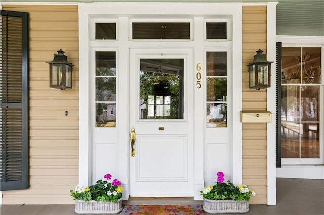 view of exterior entry with a porch