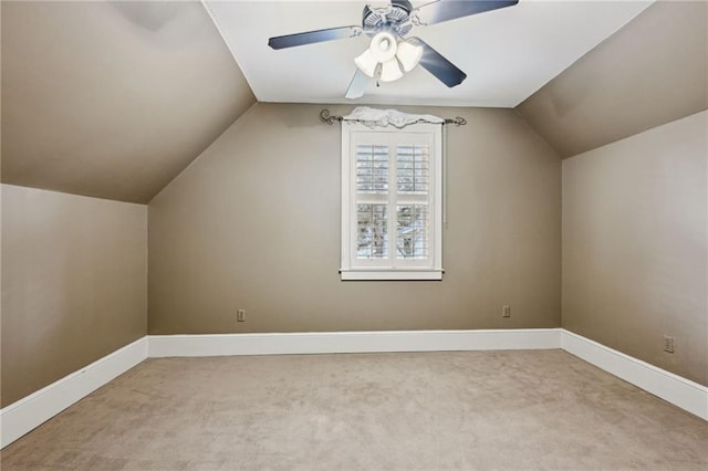 additional living space featuring baseboards, carpet floors, lofted ceiling, and a ceiling fan