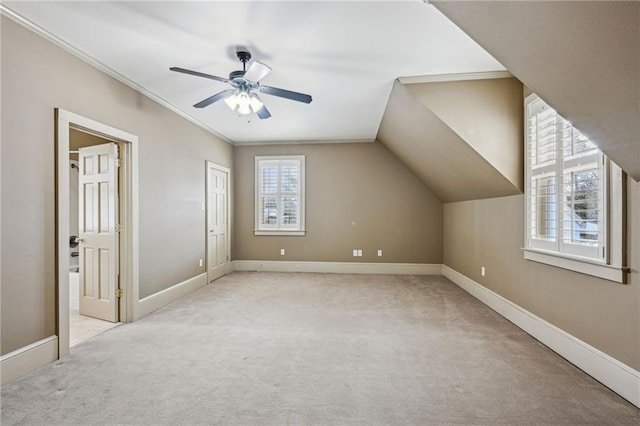 additional living space with baseboards, carpet floors, ceiling fan, and vaulted ceiling