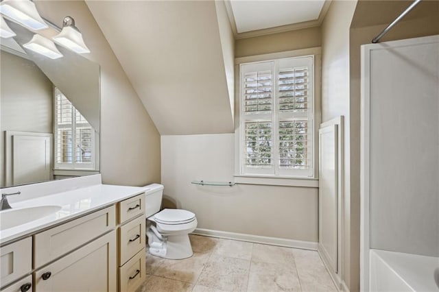 bathroom featuring toilet, lofted ceiling, a shower, baseboards, and vanity