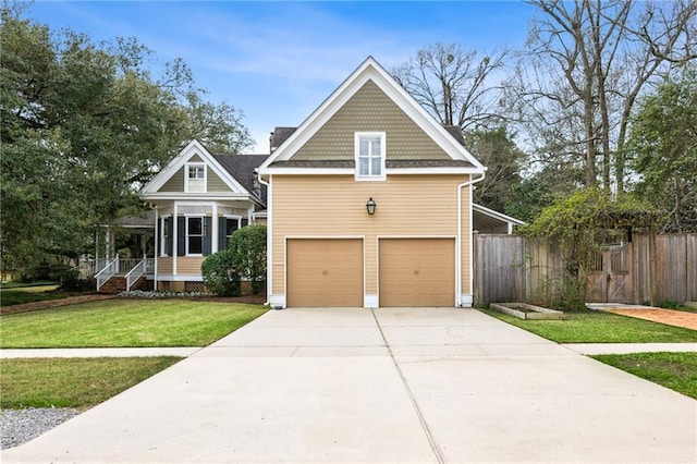 view of front of house featuring a garage, a front yard, and fence