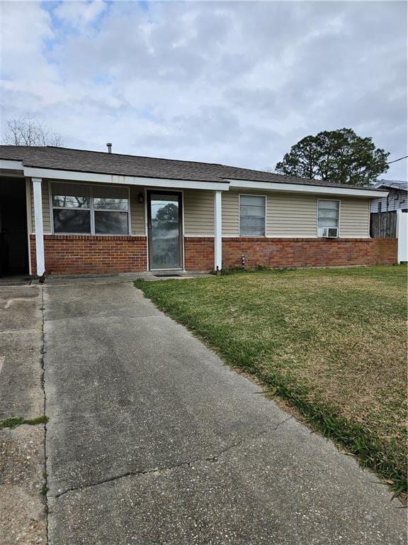 ranch-style house with a front lawn and brick siding