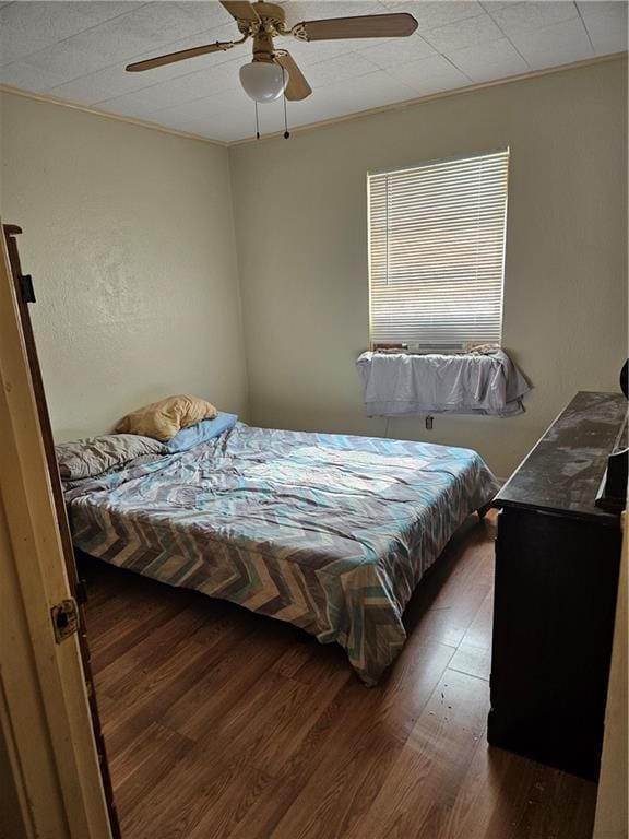 bedroom featuring wood finished floors and a ceiling fan