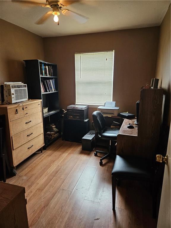 office area with light wood-style floors and ceiling fan