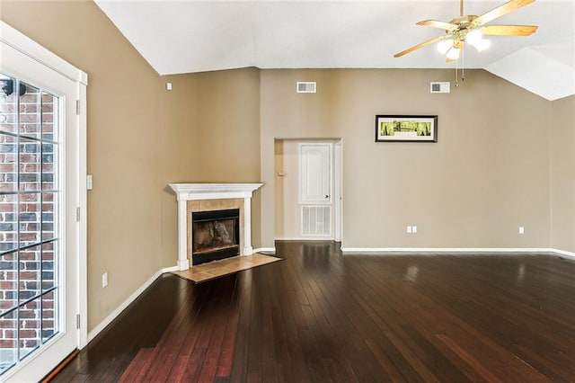 unfurnished living room with visible vents, lofted ceiling, hardwood / wood-style floors, and a fireplace