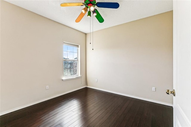 unfurnished room featuring ceiling fan, a textured ceiling, baseboards, and dark wood-style flooring