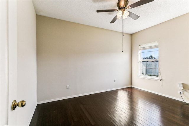 empty room featuring dark wood-style floors, ceiling fan, a textured ceiling, and baseboards