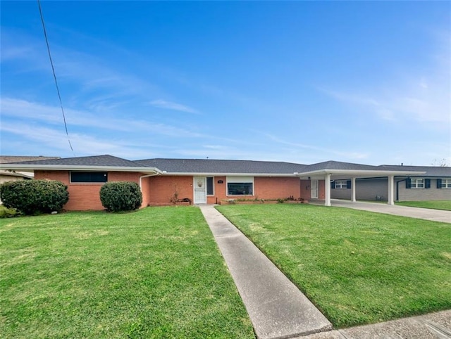 single story home with a front yard, concrete driveway, and brick siding