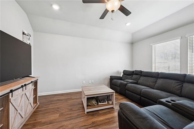 living room featuring recessed lighting, dark wood-type flooring, baseboards, and lofted ceiling