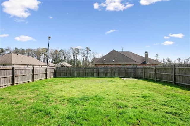 view of yard featuring a fenced backyard