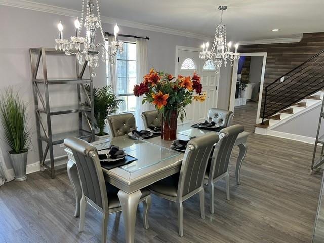 dining area featuring stairs, wood finished floors, baseboards, and ornamental molding