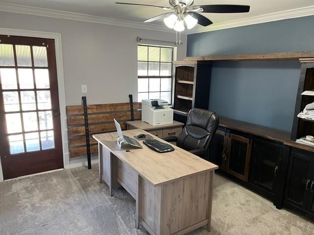 office space featuring light carpet, a ceiling fan, and ornamental molding