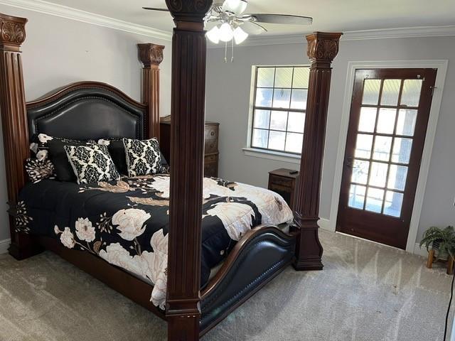 bedroom with a ceiling fan, carpet, and ornamental molding