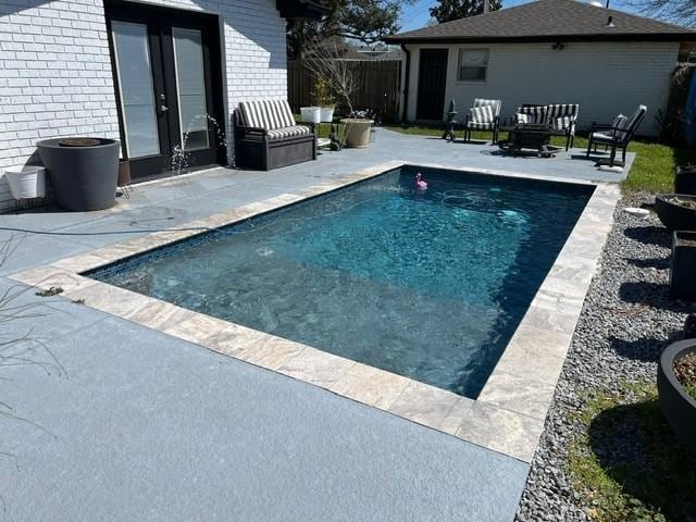 view of pool featuring a fenced in pool, a patio area, and fence