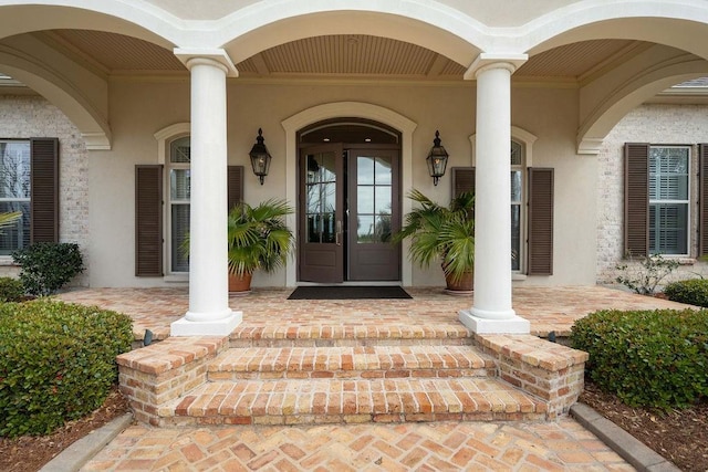 entrance to property with stucco siding and french doors