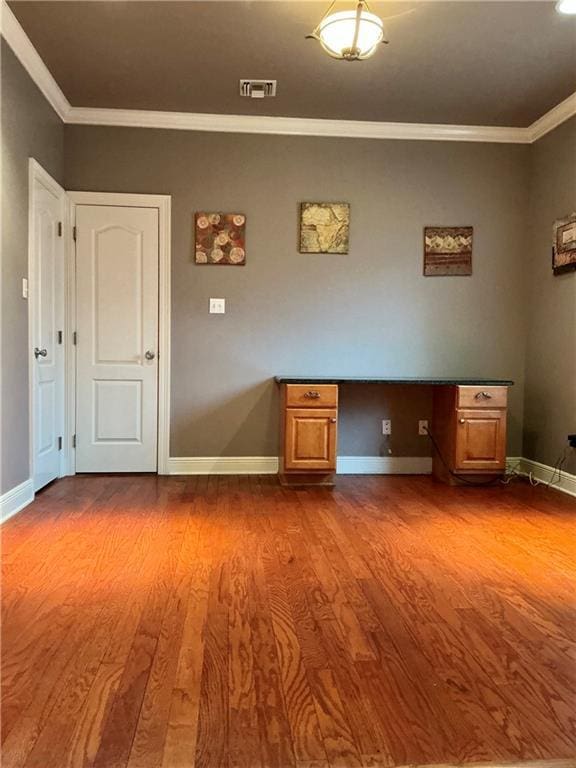 interior space with visible vents, ornamental molding, baseboards, and dark wood-style flooring