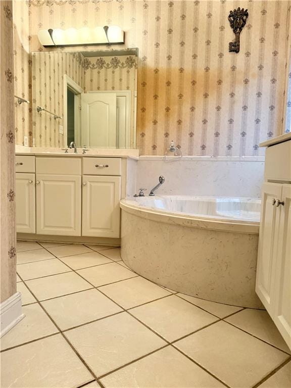 full bath with vanity, a bath, tile patterned flooring, and wallpapered walls