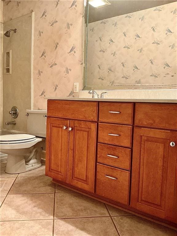 full bath with wallpapered walls, shower / washtub combination, toilet, tile patterned floors, and vanity