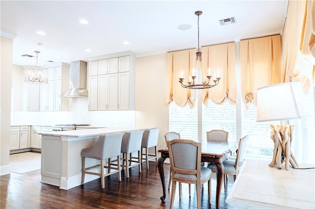 dining area featuring dark wood-style floors, visible vents, recessed lighting, and an inviting chandelier