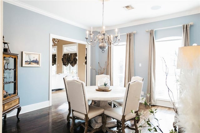 dining room with a wealth of natural light, visible vents, and crown molding