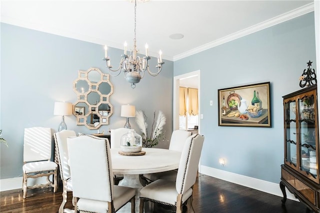 dining space with baseboards, wood finished floors, a notable chandelier, and ornamental molding