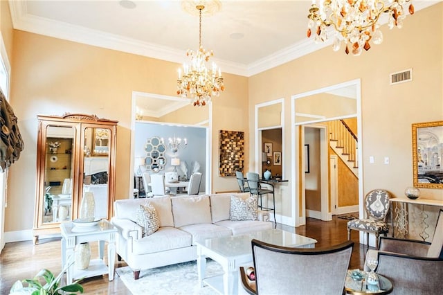 living area with a chandelier, visible vents, and wood finished floors