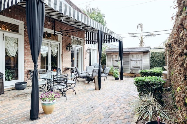 view of patio featuring an outdoor structure and outdoor dining area