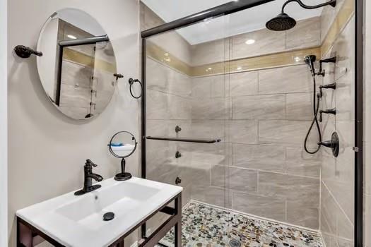 bathroom featuring a shower stall and vanity