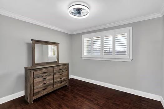 bedroom featuring dark wood-style floors, baseboards, and ornamental molding