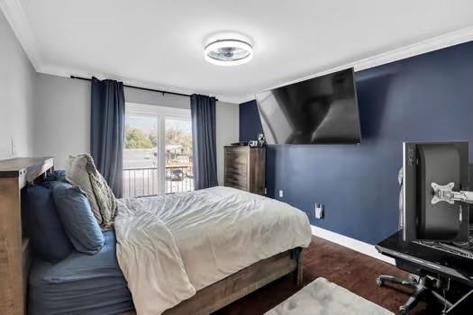 bedroom with ornamental molding, baseboards, and wood finished floors