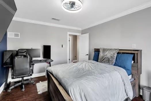 bedroom with dark wood-type flooring, baseboards, visible vents, and ornamental molding