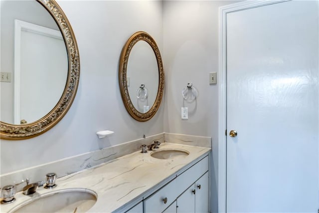 full bathroom with double vanity and a sink