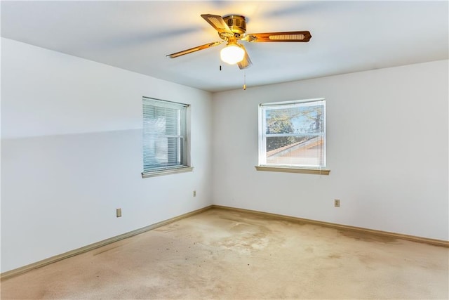 empty room featuring carpet, baseboards, and ceiling fan