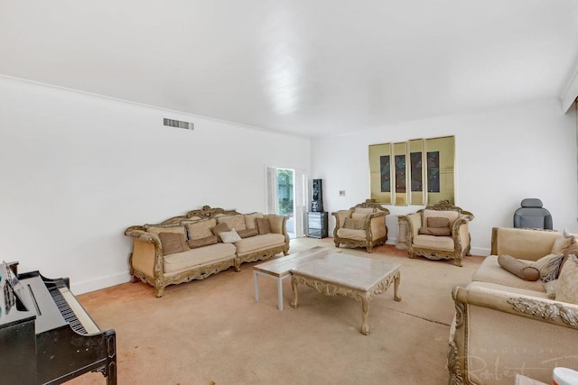 carpeted living area featuring visible vents and baseboards