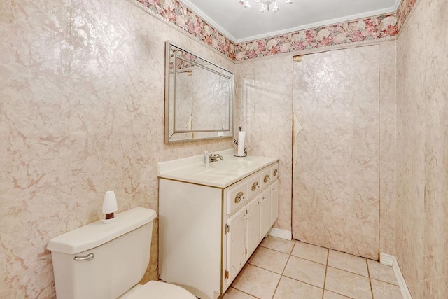 bathroom with wallpapered walls, toilet, vanity, and tile patterned flooring