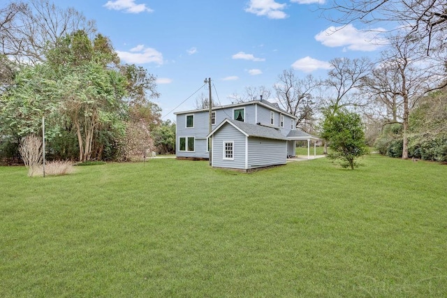back of house with a chimney and a yard